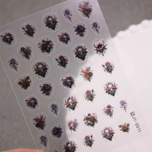 Gothic nail art stickers with skull and rose motifs in dark red and purple tones