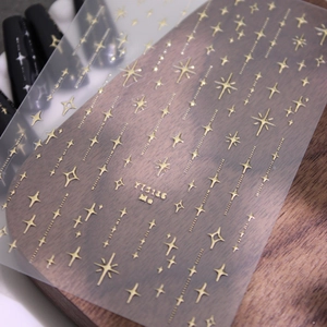 Stickers à ongles étoiles dorées métallisées avec divers motifs de croix pour nail art