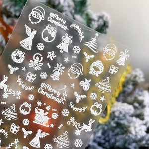 3D embossed white Christmas nail decals with Santa, snowflakes and tree designs