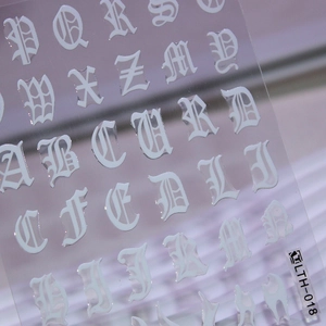 Gothic style white alphabet nail art decals with embossed texture and gold silver finish