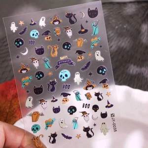 Halloween nail art stickers with colorful ghosts, skeletons and cats for festive decoration