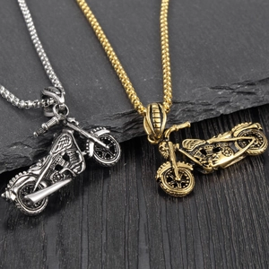 Retro motorcycle skull pendants in gold and silver steel with detailed engine texture