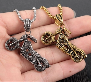 Close-up of vintage biker pendant showing intricate motorcycle details and metallic finish