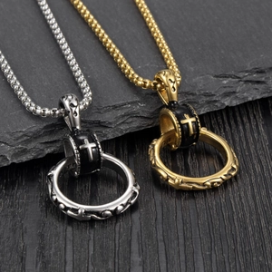 Retro hip-hop cross pendant necklace in gold and silver steel on dark stone background