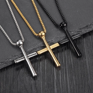 Detailed view of baseball bat cross pendants in silver, gold, and matte black finishes