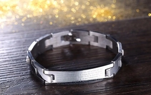 Detailed macro view of stainless steel bracelet with laser engraved Lord's Prayer text