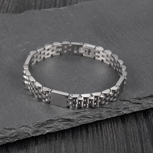 Detail of silver stainless steel watch-style bracelet with jubilee links and engraving