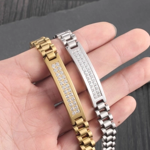 Close-up of gold and silver men's watchband bracelets with sparkling CZ stone inlay