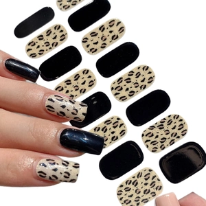 Leopard print and solid black nail stickers showing realistic application on nails