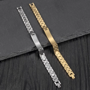 Detail of gold and silver stainless steel watch-link bracelets on stone background