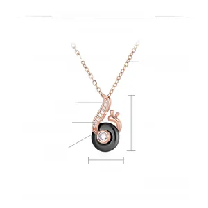 Detail view of snail pendant with black ceramic, rose gold steel, and cubic zirconia