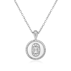 Macro detail of silver layered round pendant with zircon center and shimmering pavé accents
