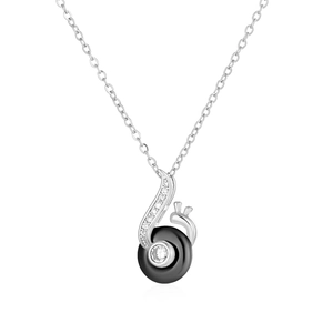 Macro view of silver note pendant with black ceramic circle and shimmering center stone