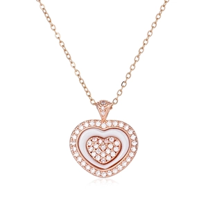 Detailed view of rose gold heart pendant with diamond accents and white inlay detail