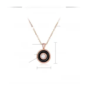 Detail of rose gold pendant featuring concentric rings with black ceramic and cubic zirconia