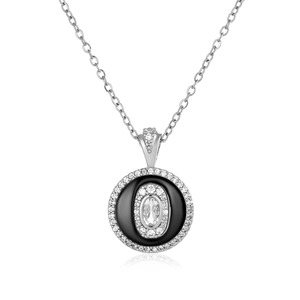 Detailed view of silver necklace featuring a sparkling pavé zircon and black enamel pendant