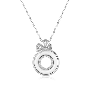 Detail of elegant bow pendant with white ceramic rings and sparkling cubic zirconia stones
