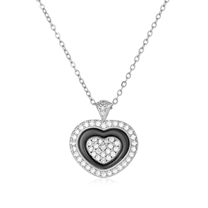 Macro view of heart pendant necklace with black enamel inlay and white crystals