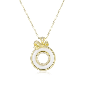 Minimalist gold necklace with white ceramic round pendant and diamond bow knot accent