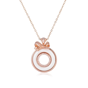 Detail of rose gold bow necklace with ceramic pendant and shimmering diamond inlay