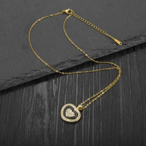 Elegant gold-plated stainless steel heart necklace with inlaid crystals on a black base
