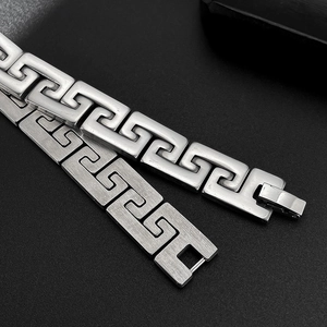 Detail of silver Greek key link bracelet showing mirror polished and brushed matte finishes