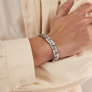 Men's stainless steel punk bracelet featuring Greek Greca pattern on a male wrist