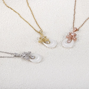 Pendentifs gouttes en céramique avec motifs floraux en or, or rose et finitions argentées