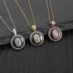 Elegant circular necklaces in gold, silver, and rose gold finishes on a dark textured background