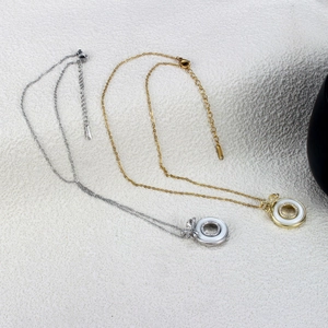 Elegant gold and silver bow necklaces with ceramic double ring pendants and zircons