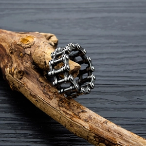 Industrial bike chain ring in vintage silver finish on natural wood background