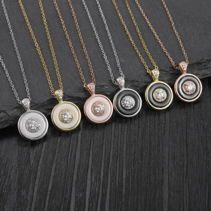 Minimalist round crystal pendant necklaces in gold and silver finish on stone background