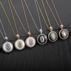 Macro shot of circular pendant necklaces with enamel inlay and pavé diamonds details