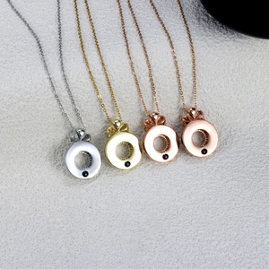 Close-up of bow knot necklaces in silver, gold, and rose gold with black beads