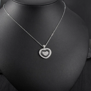 Close-up of triple-layered heart pendant with black enamel and white crystal pavé