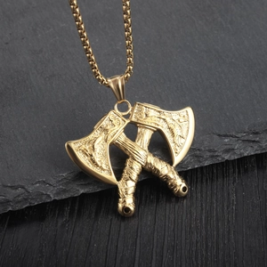 Detailed view of the gold double axe pendant with intricate Viking relief patterns