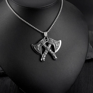 Detail of Viking double axe pendant with Nordic carvings on a black jewelry bust