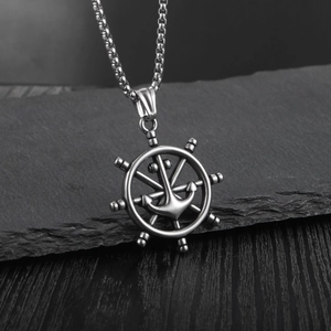 Vintage titanium steel ship helm and anchor pendant necklace on black slate background