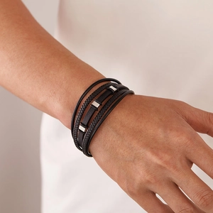 Close-up of multilayer black woven leather bracelet with polished silver metal buckle