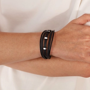 Detail of multi-layer black braided leather bracelet with three silver metal accents