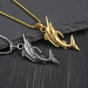 Detailed close-up of gold and silver marlin pendants with textured swordfish scales