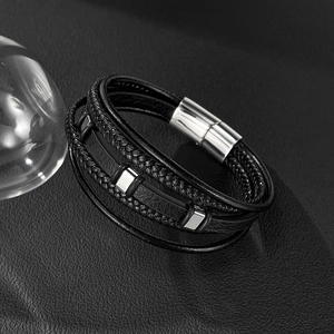 Macro detail of multilayer braided leather bracelet with silver magnetic clasp for men