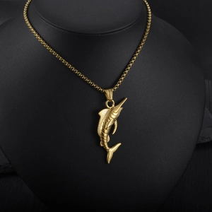 Detailed close-up of golden marlin fish pendant with textured scales on black bust display