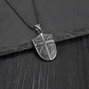 Retro U-shaped shield cross pendant necklace for men on a dark rock background