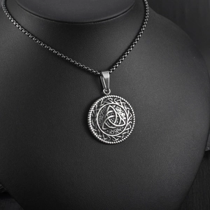 Detail view of vintage Celtic Triquetra knot pendant on black professional bust display