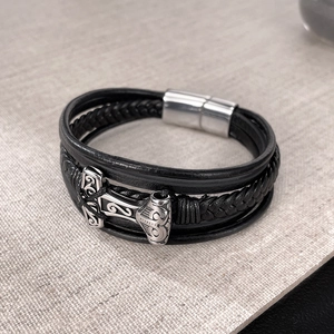 Detail of multi-layer black leather bracelet with silver Thor hammer Mjölnir pendant