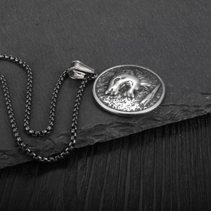 Detail of retro wolf head medallion pendant on a square link steel chain necklace