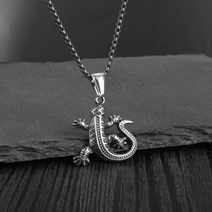 Vintage stainless steel gecko lizard pendant necklace with box chain on dark rock