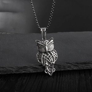 Vintage silver owl pendant necklace with Celtic knot patterns on a stainless steel chain
