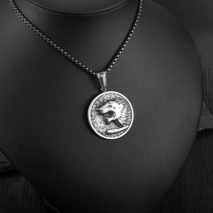 Close-up of retro wolf head relief pendant on square box chain displayed on bust